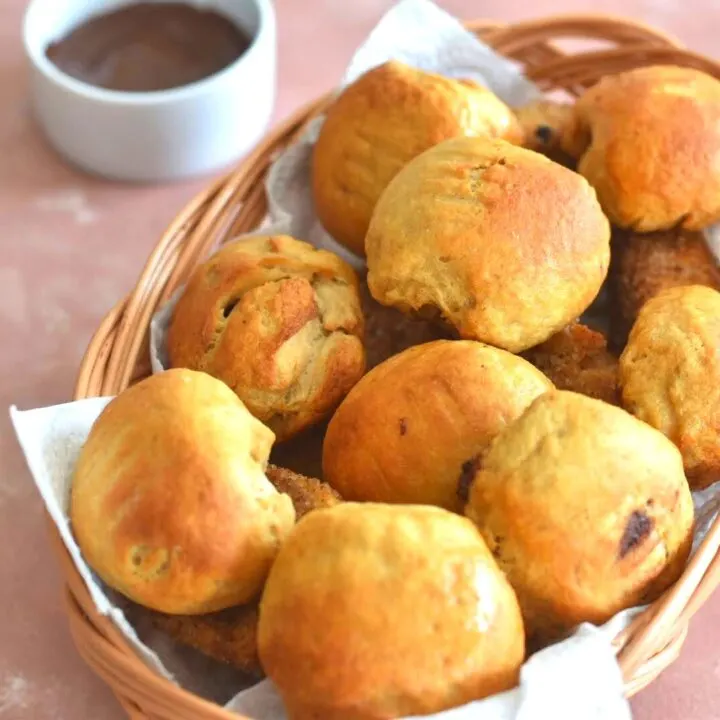 Cheese and chocolate Stuffed Pretzel Bites served in a brown bread basket with some chocolate on the side