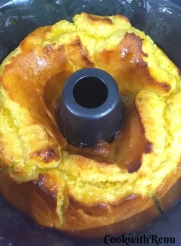 Baked Yeast Bundt Cake, hot and drizzled with orange syrup in the Bundt pan.