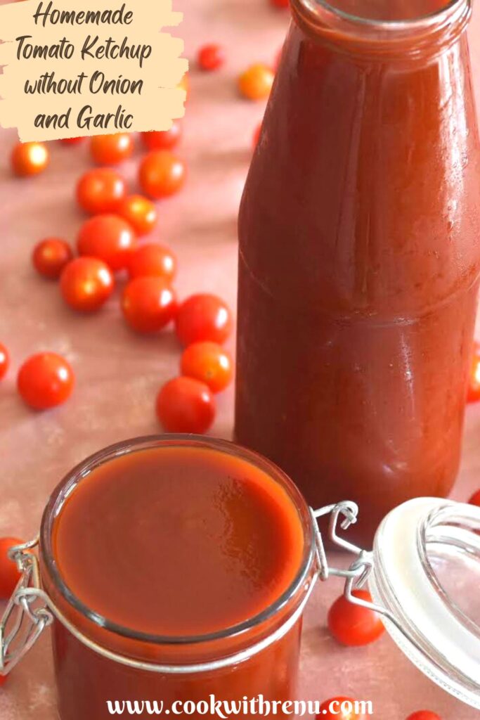 Tomato ketchup in a glass jar and a glass bottle with some cherry tomaotes lying all over.