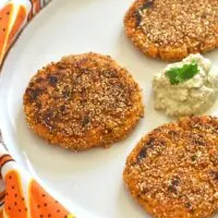 Pumpkin Sweet Potato and Amaranth Patties served on a white plate with some chutney.
