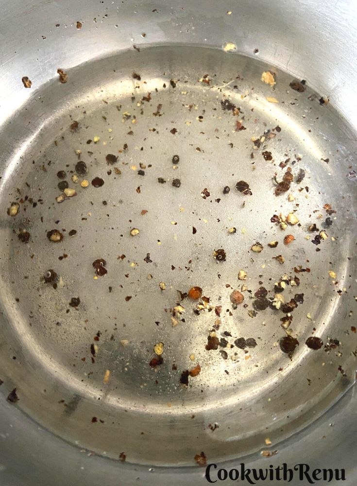 Vinegar, along with salt and pepper in a pot.