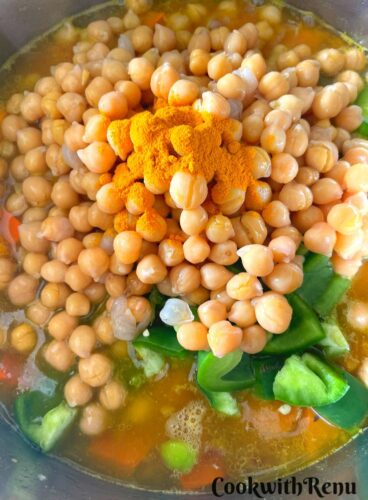 Adding of chickpeas and turmeric.