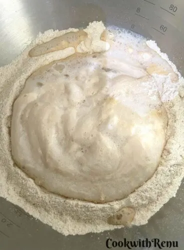 Adding of yeast mixture in dough.