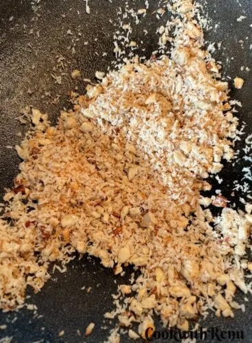 Roasting of nuts and desiccated coconut in an Iron wok.