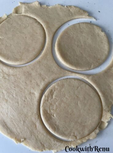 Rolling the gujiya into big round and then cutting into smaller disc using a cookie cutter.