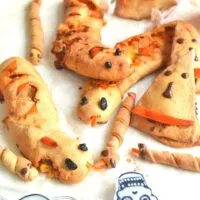 Spooky Halloween Stuffed bread arranged on a white parchment paper.