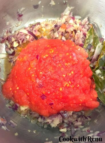 Adding of Tomato Puree in the pot.