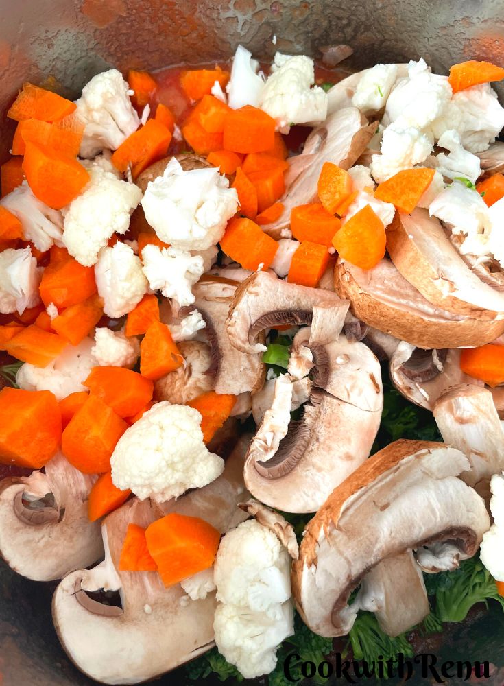Adding of Vegetables in the onion and tomato mixture in the pot.