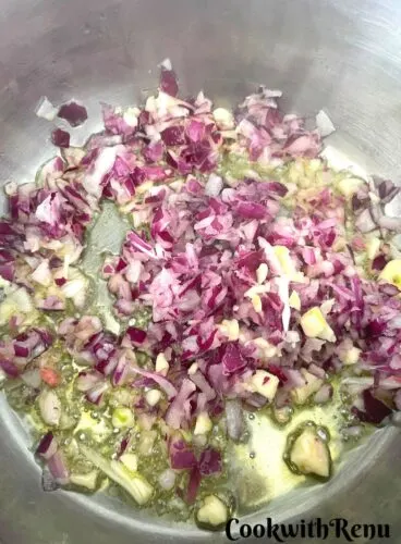 Adding of onion and garlic in oil.