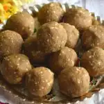 Close up view of Bajra Ladoo served in a golden plate.