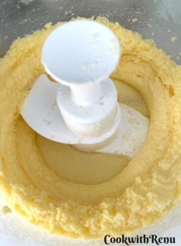 Whipping the split buttercream in a food processor.