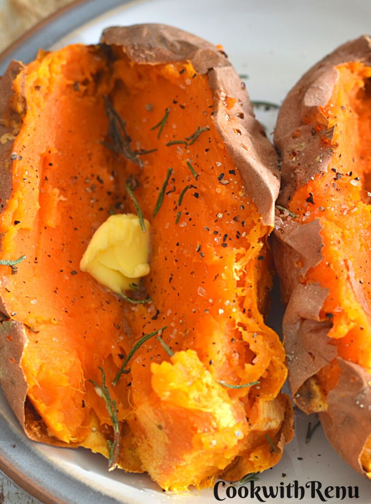 Air Fryer Baked Sweet Potato served with a dollop of butter and rosemary, black pepper powder and salt sprinkled on it.