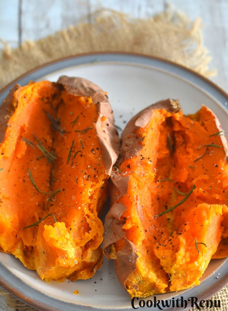 2 Air Fryer Baked Sweet Potato served with rosemary, black pepper powder and salt sprinkled on it. They are served on a white plate with grey border.