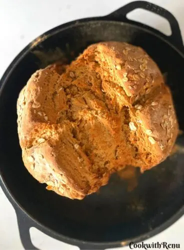 Just Baked Irish Brown Soda Bread on a cast iron pan.