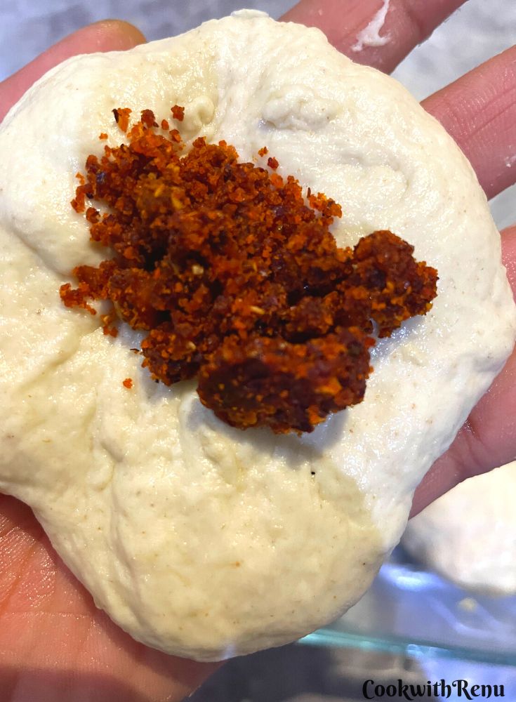 Adding of chutney in bread.