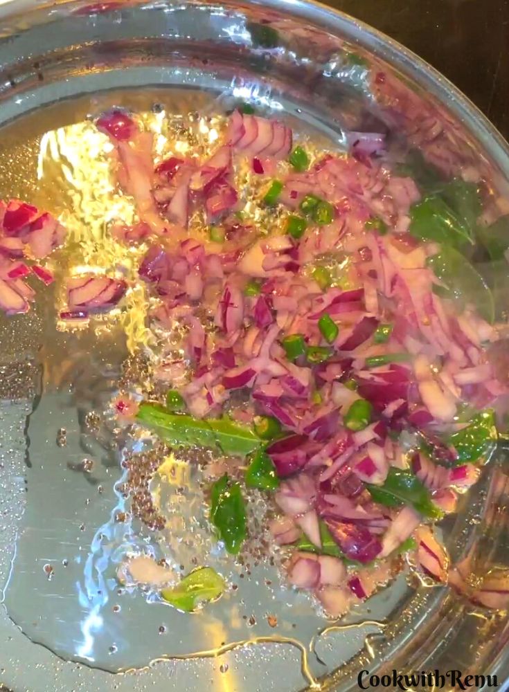 Adding onion and green chili in oil.