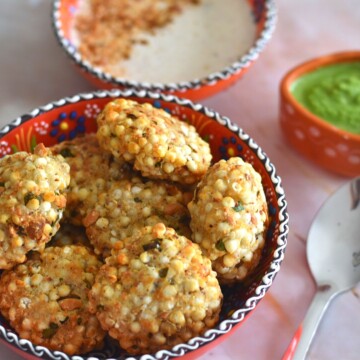 Air Fryer Sabudana Vada in a orange bowl wtih some chutney and yogurt peanut dip.