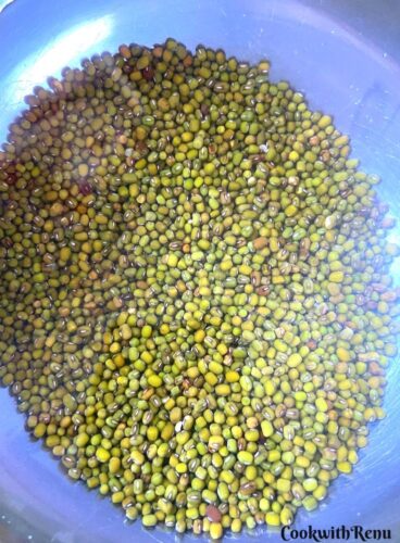 Mung beans getting soaked in a bowl.