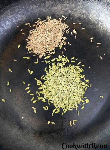 Roasting of Fennel and Cumin Seeds in a cast iron pan.