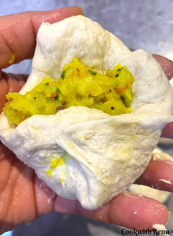 Sealing the potato and chutney filling in the dough,