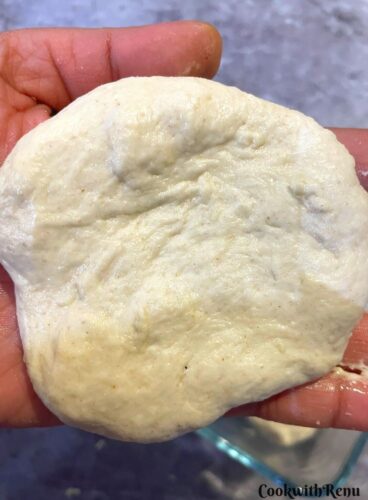 Shaping the pav for baked vada pav. Flatting of the dough balls on the palm.