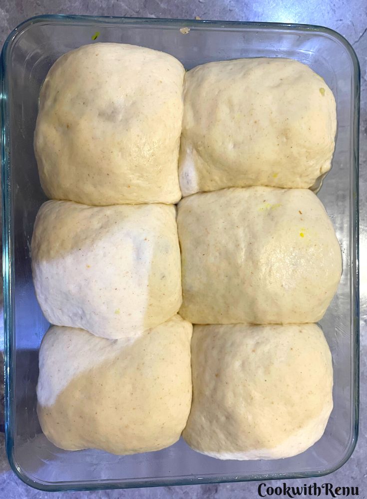 Vada Pav ready to be baked in a baking tray.