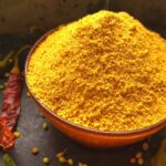 Easy Sambhar masala in a bowl with some spices scattered around.