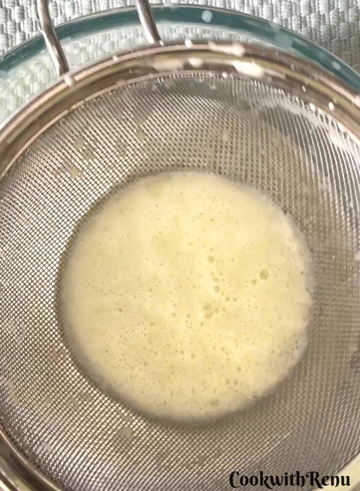 Coconut milk is removed by squeezing coconut using a sieve and a bowl.