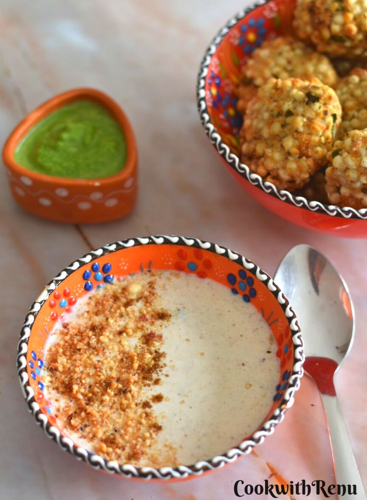 Farali Singdana Raita served in a designer orange bowl, with some air fryer sabudana vada and green chutney on the side.
