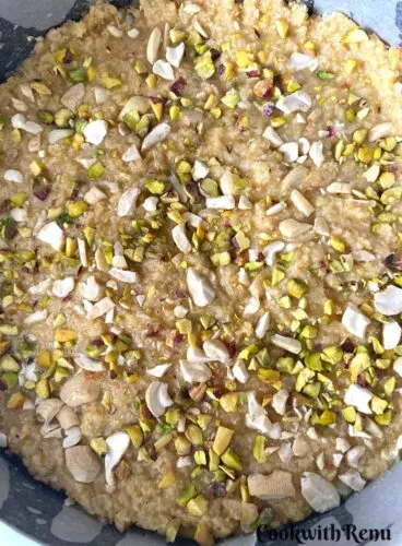 Goan Baath Cake garnished with nuts and ready to be baked.