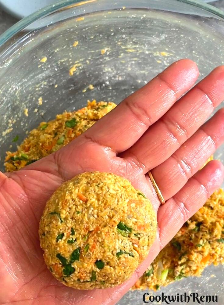 Shaping the sweet potato and oats mixture into a patty.