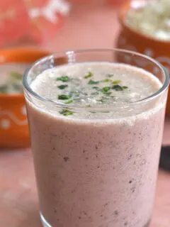 Close-up look of Solkadhi or Kokum coconut curry in a glass.