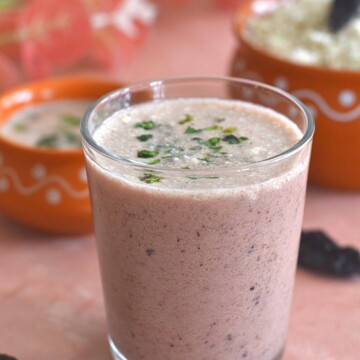 Close-up look of Solkadhi or Kokum coconut curry in a glass.