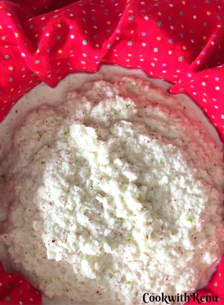 Straining coconut milk using a sieve.