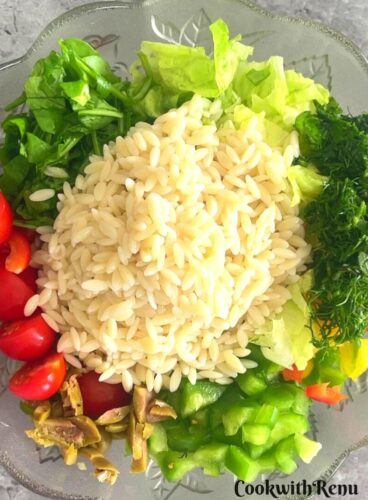 Adding of Orzo pasta in vegetables.