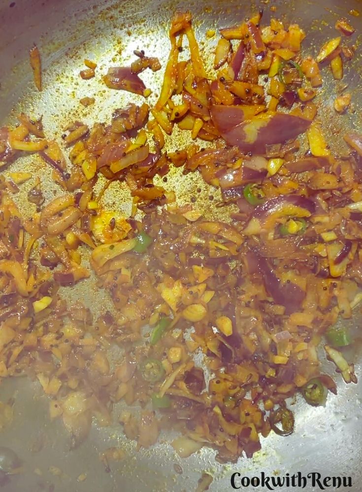 Cooking of onion and garlic in a pan.