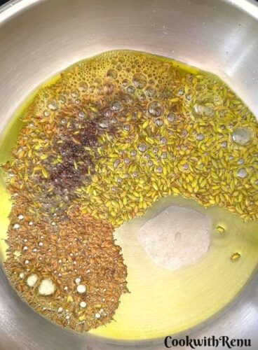Fennel, Mustard, and Cumin seeds are added to oil.