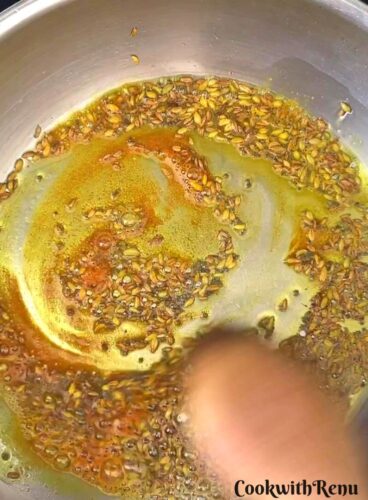 Turmeric powder is added to the oil.