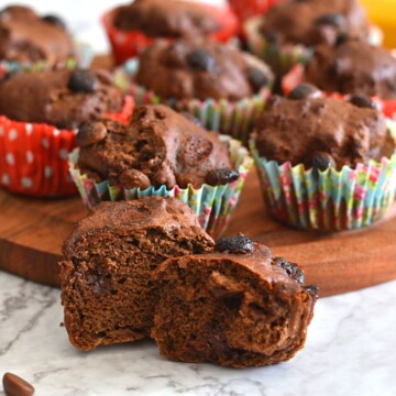 Close-up look of Avocado banana muffins showing the inside texture. Seen in the background are more muffins.