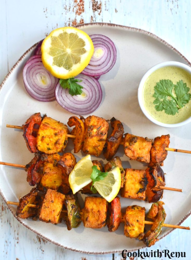 Vegan Tofu Tikka served in a plate along with onion and mint chutney.