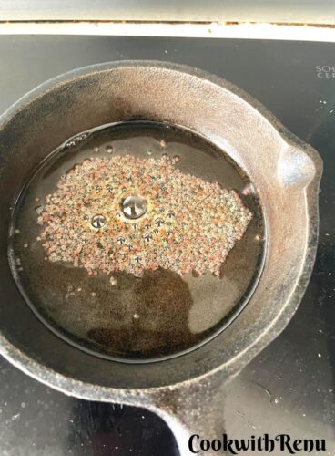 Adding of mustard seeds in oil.