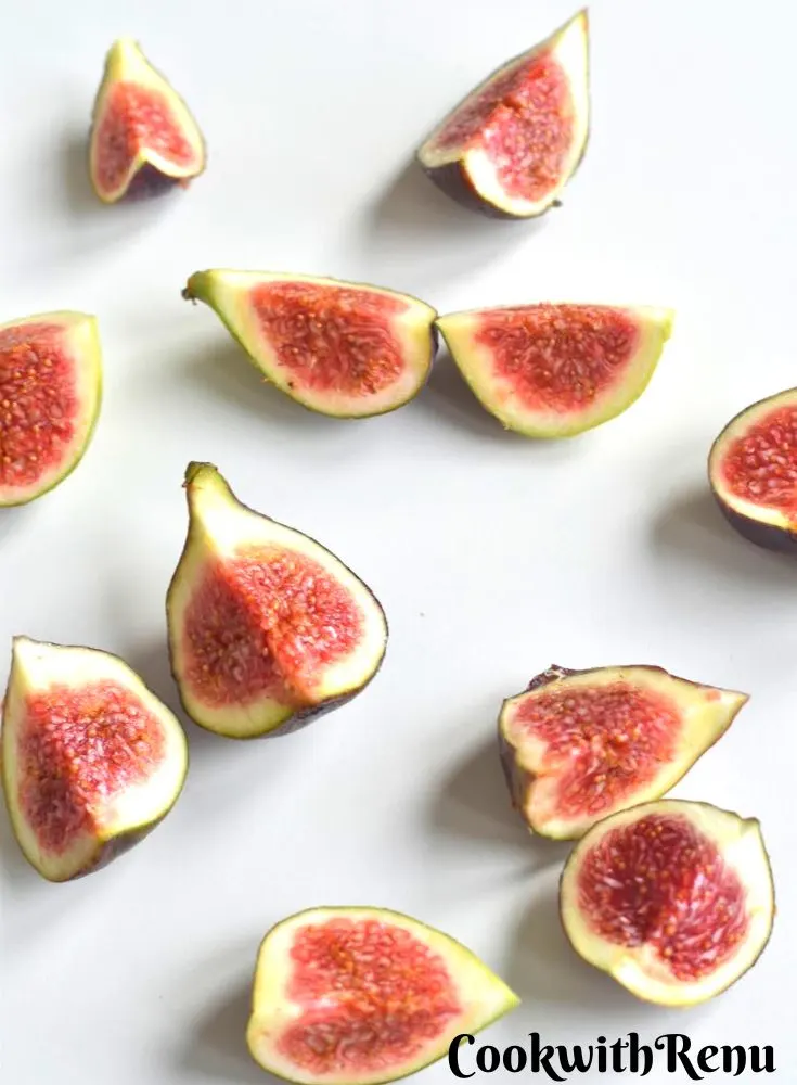 Chopped Figs on a white board.