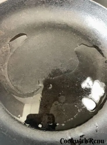 Oil added to a cooking pan.