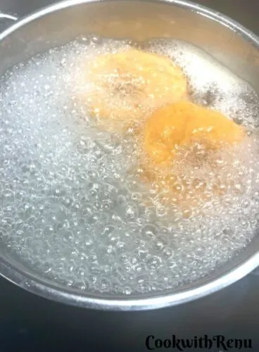 Water Bathing of Bagels in hot boiling water.