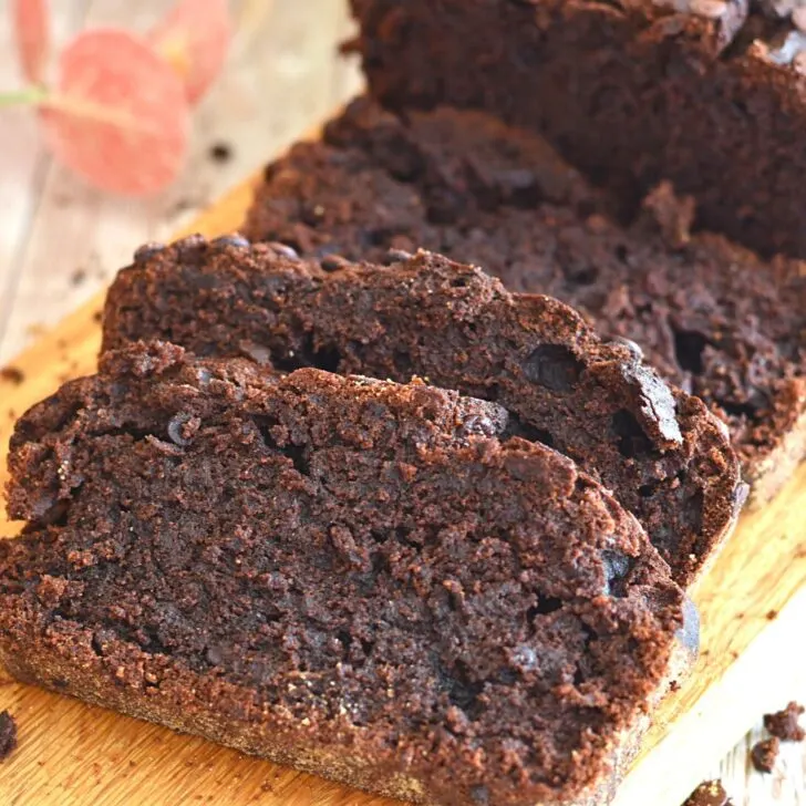 Slices of close up texture of double Chocolate Whole Wheat Banana Bread on a brown board.