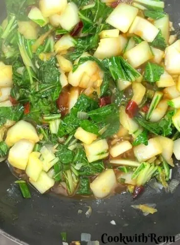 Cooking of Bok Choy in a wok.