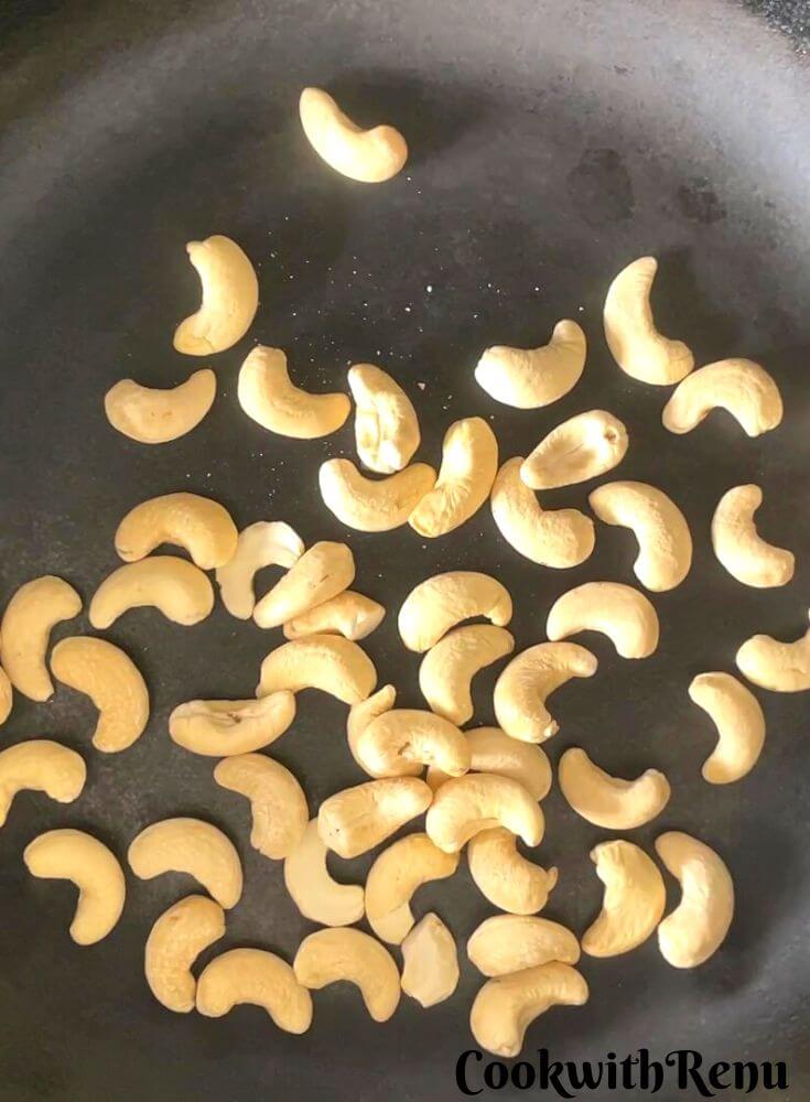 Roasting of cashews in a pan.