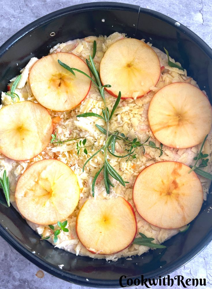 Shaped and topped Focaccia ready to be baked in a 9-inch round tin.