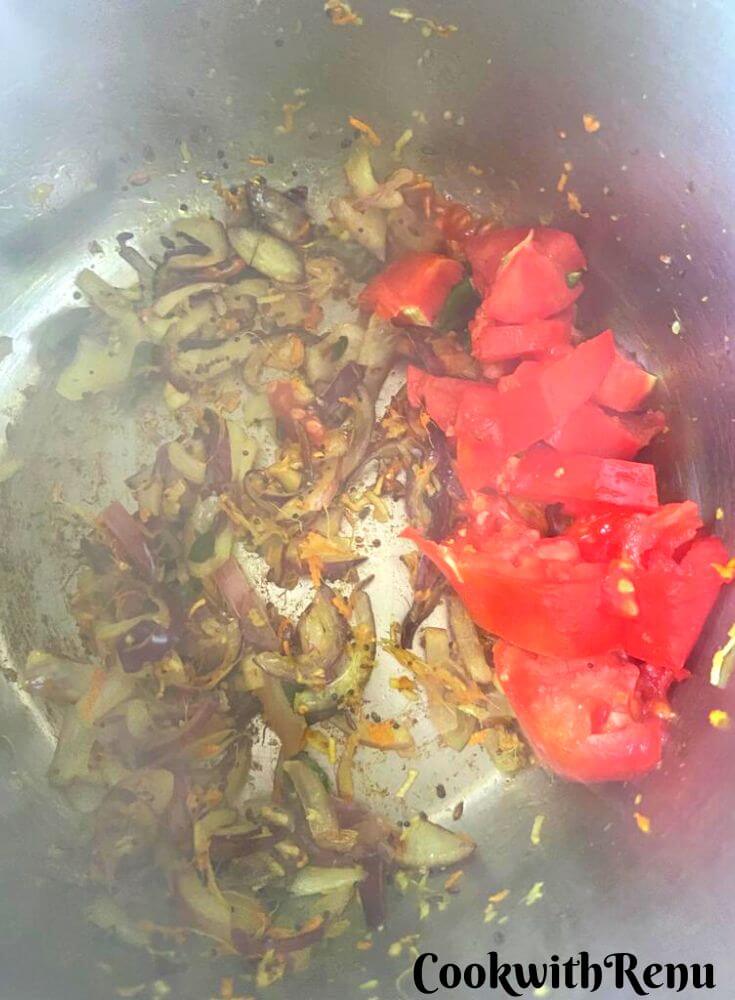 Tomatoes added to oil and onion in Instant pot.