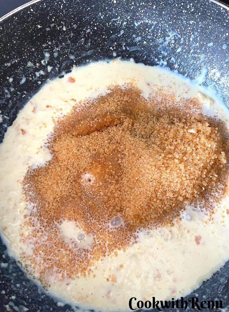 Adding Sugar in Rabri in a wok.